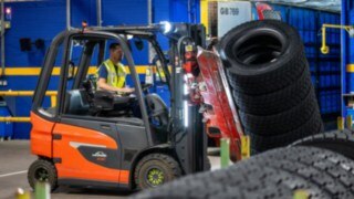 Un empleado de Michelin Tyre PLC sujeta una pila de neumáticos con una pinza montada en la carretilla elevadora.