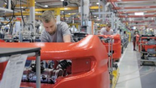 Nuestro concepto de plataforma con montaje mixto permite una conservación eficaz de los recursos. Varios mecánicos de fábrica trabajan en vehículos Linde.